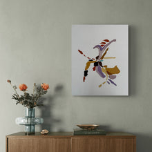 An abstract canvas art print featuring purple, gold, and red brushstrokes on a white background, displayed on a textured gray wall above a wooden console table with a glass vase of flowers.