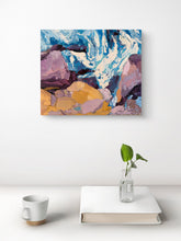 Just One More Wave textured coastal painting in blue, white and lilac displayed above a minimalist white table