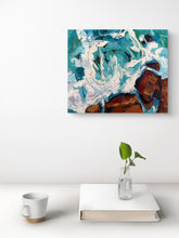 Stay A While turquoise ocean waves painting displayed on a white wall above a minimalist table with a plant and mug